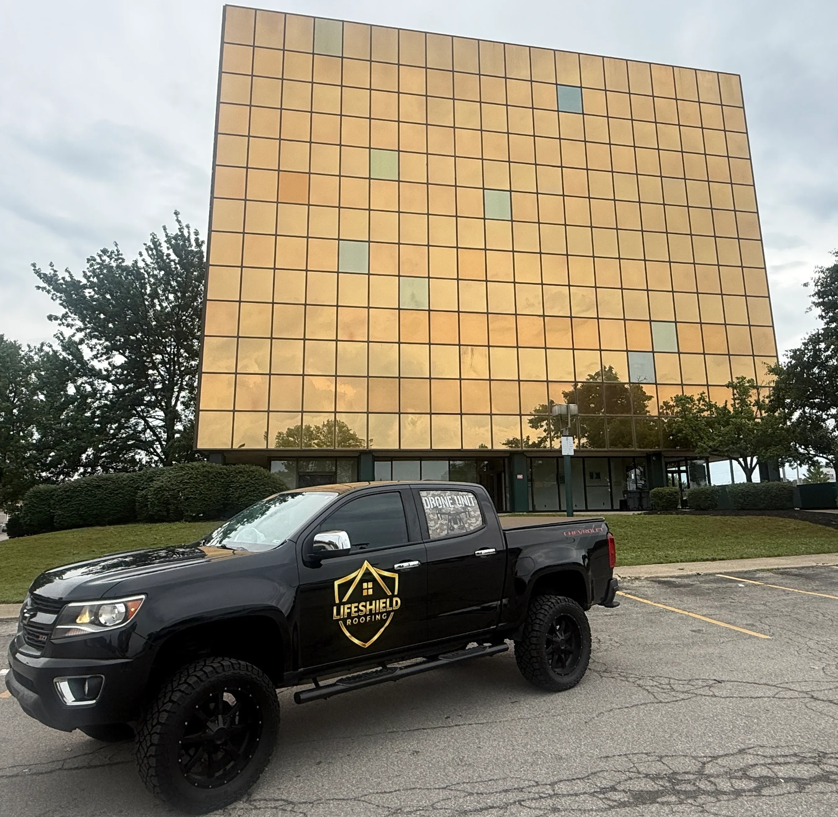 Metal panel roof with tan and bronze cladding on commercial building facade